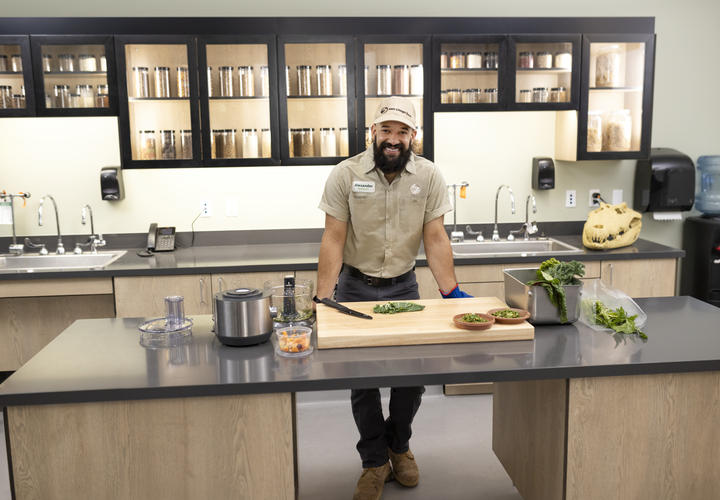 San Diego Zoo Keeper in a zoo kitchen, smiling at camera