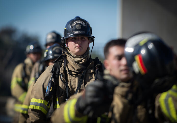 Fire cadets line up while doning fire fighting gear