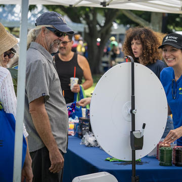 Image of female SDG&E employee smiling with a male participant at the Wildfire Safety Fair.