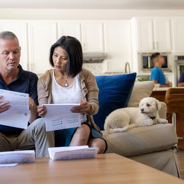 A couple sits on the couch, reviewing their SDG&E bill