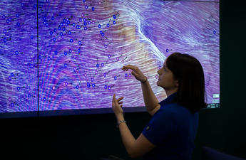 SDG&E Meteorologist stands in front of a monitor depicting high winds