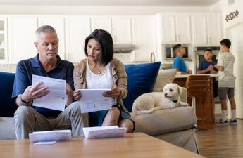 A couple sits on the couch, reviewing their SDG&E bill