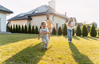 Family looking at home with solar panels