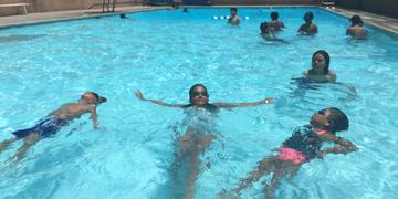 Kids learning how to swim at the Barrio Station Pool. 