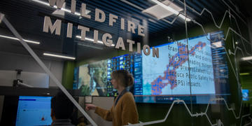 Image of female and male SDG&E employee working within the Wildfire Mitigation workspaces, within the Wildfire Climate and Resilience Center