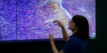 SDG&E Meteorologist stands in front of a monitor depicting high winds